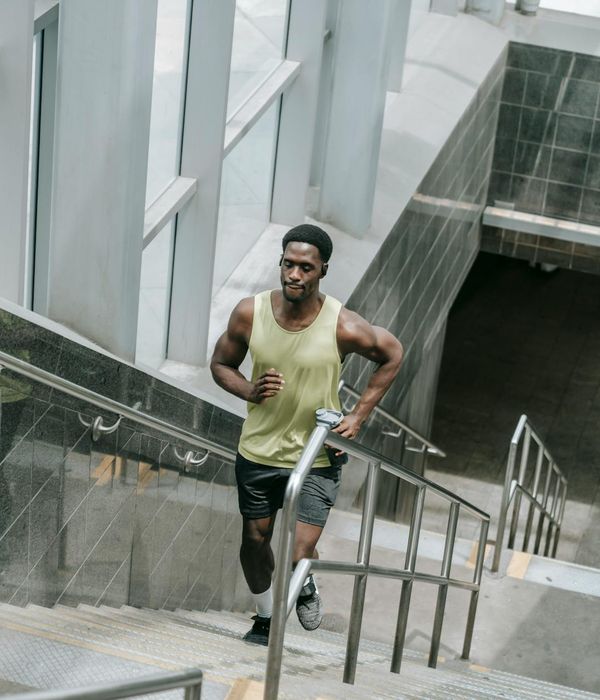 Man performing a strength exercise in a modern gym setting.